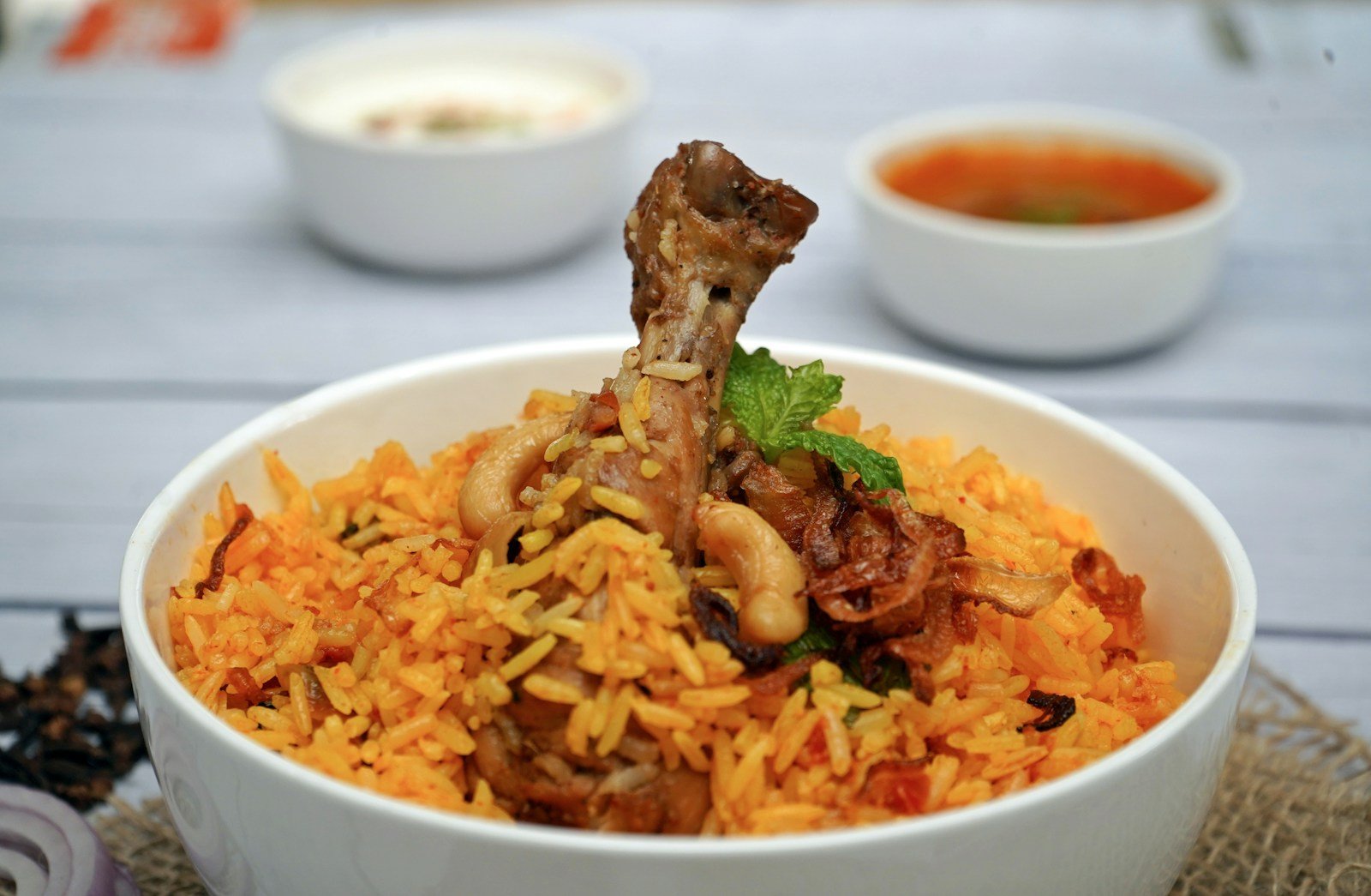 Chicken biryani served with herbs